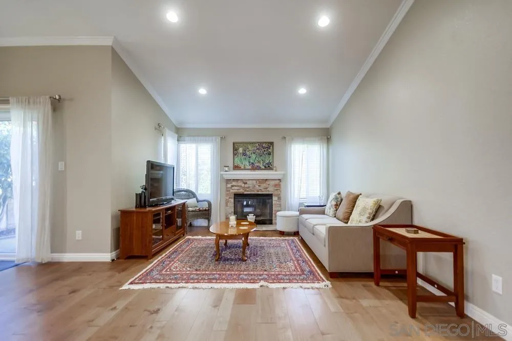 3797 Fallon Circle San Diego, CA 92130 - Photo 5 of 37 a living room with furniture a fireplace and a flat screen tv