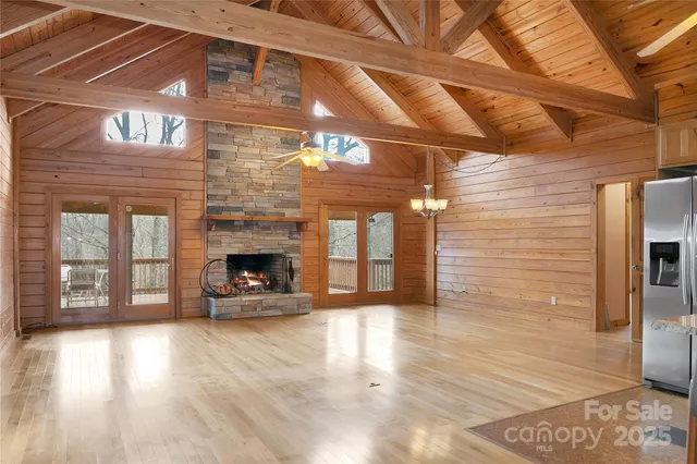 a view of a livingroom with wooden floor and a fireplace