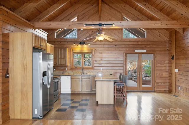 a kitchen with stainless steel appliances granite countertop a refrigerator and wooden cabinets