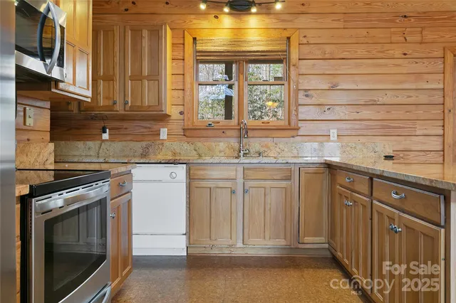 a kitchen with stainless steel appliances granite countertop a stove and a sink