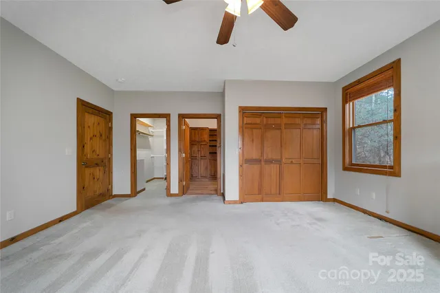 an empty room with windows and closet