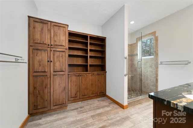 a view of an empty room with cabinet and a window