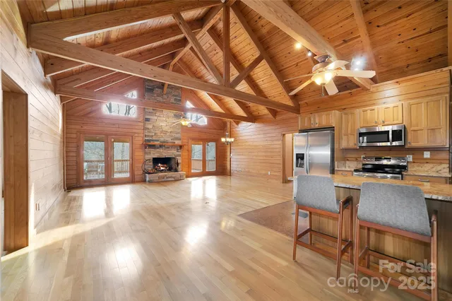 a view of a kitchen with a sink a counter space and stainless steel appliances