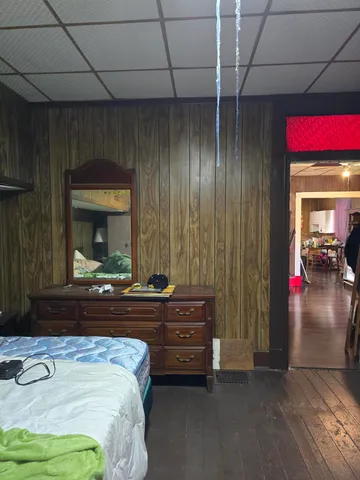 a bedroom with a bed and a mirror