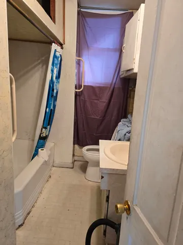a bathroom with a toilet and a rug