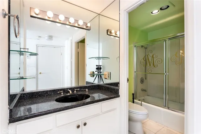 a bathroom with a toilet sink and shower