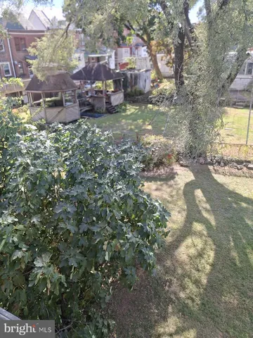 a backyard of a house with yard and outdoor seating