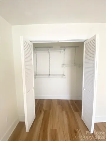 a view of a room with wooden floor