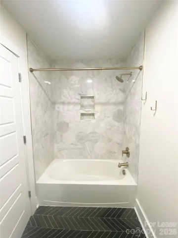 a bathroom with a bathtub and a shower