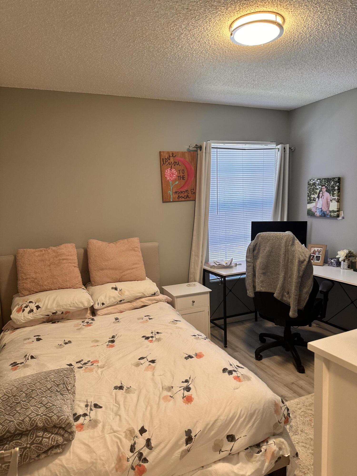 2800 Palmwood Terrace, Unit P221 Boca Raton, FL 33431 - Photo 14 of 16 a bedroom with a bed and wooden floor