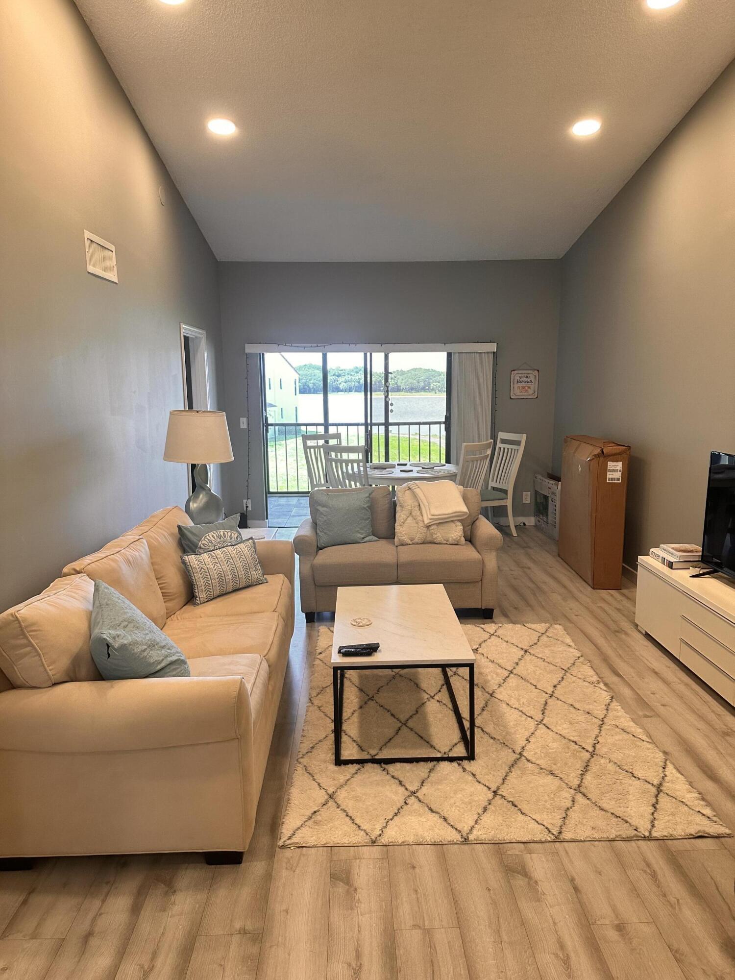 2800 Palmwood Terrace, Unit P221 Boca Raton, FL 33431 - Photo 5 of 16 a living room with furniture and a window