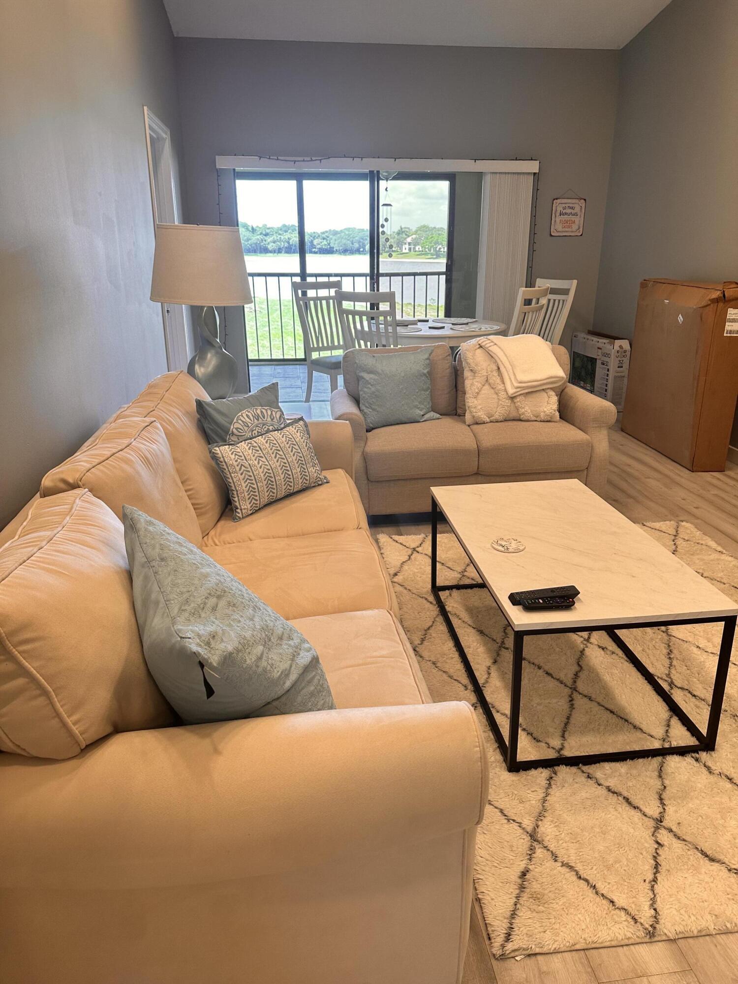 2800 Palmwood Terrace, Unit P221 Boca Raton, FL 33431 - Photo 6 of 16 a living room with furniture and a floor to ceiling window