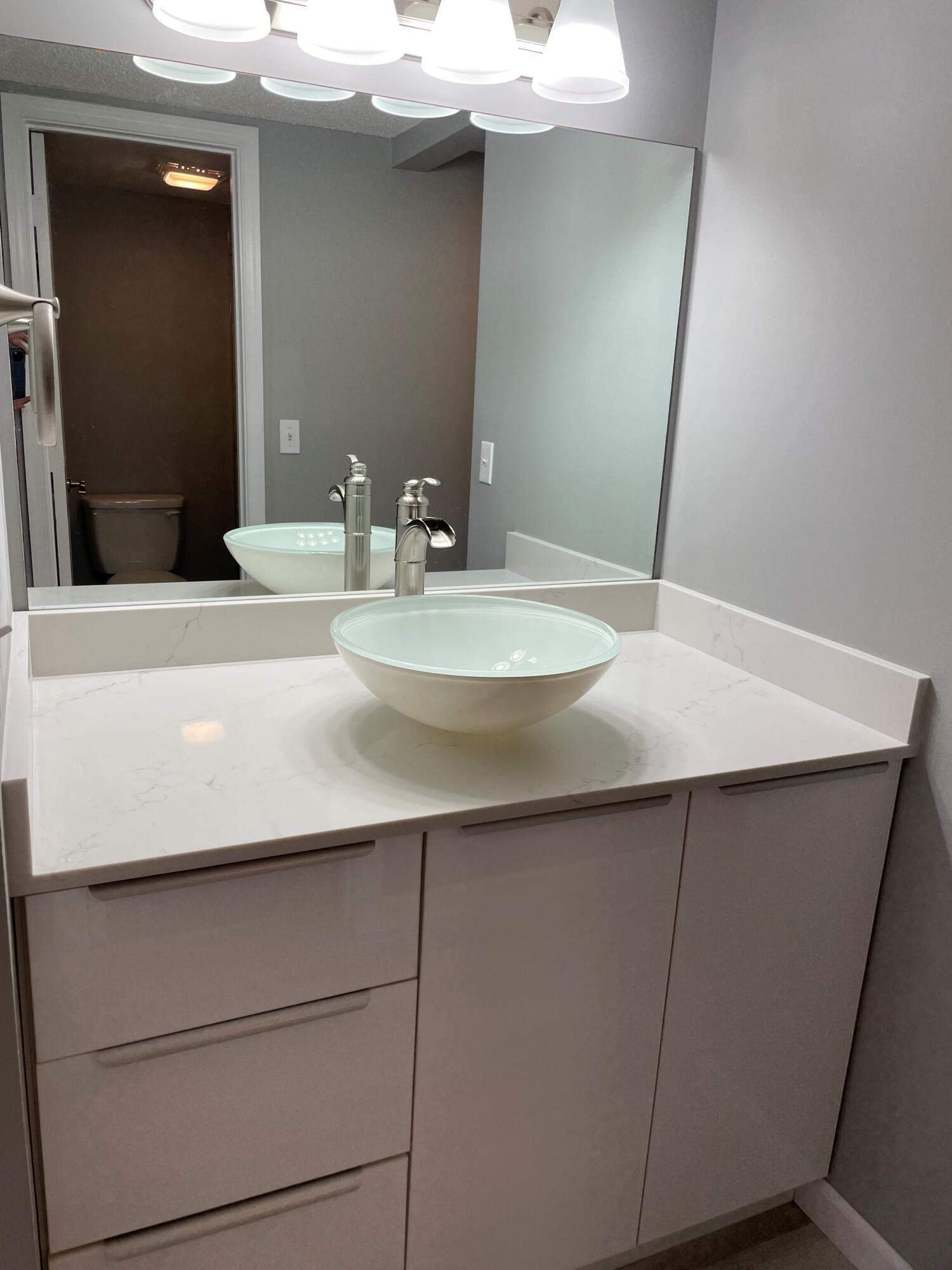 2800 Palmwood Terrace, Unit P221 Boca Raton, FL 33431 - Photo 10 of 16 a bathroom with a sink and a mirror