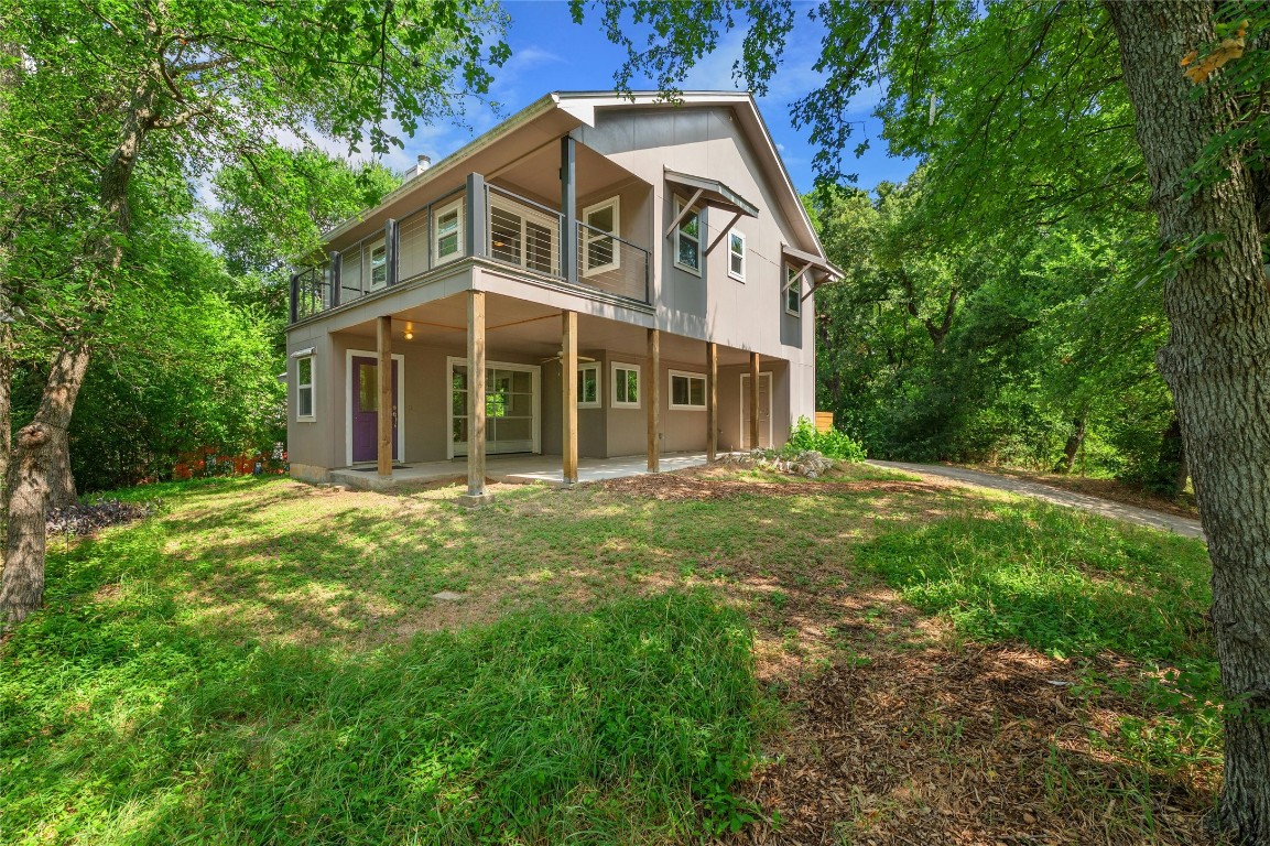 a view of a house with yard and sitting area