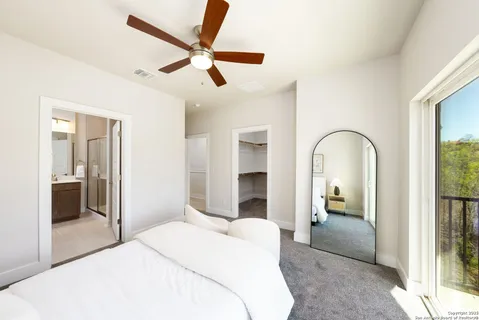 a bedroom with a bed and a large mirror