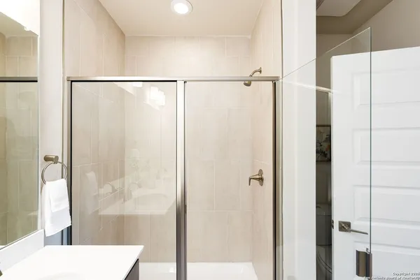 a bathroom with a shower and a sink