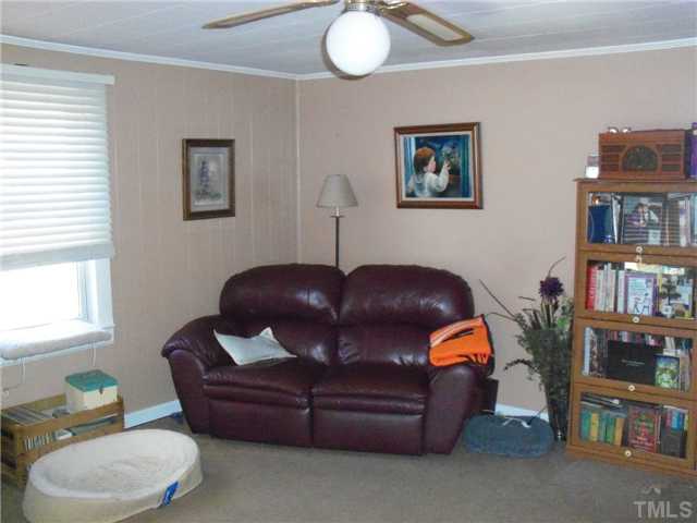 1234 Pointer Street Roxboro, NC 27573 - Photo 4 of 17 Living room offers plenty of sunlight, carpet, levlor plantation blinds