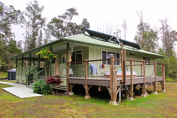 a view of house with swimming pool and sitting area