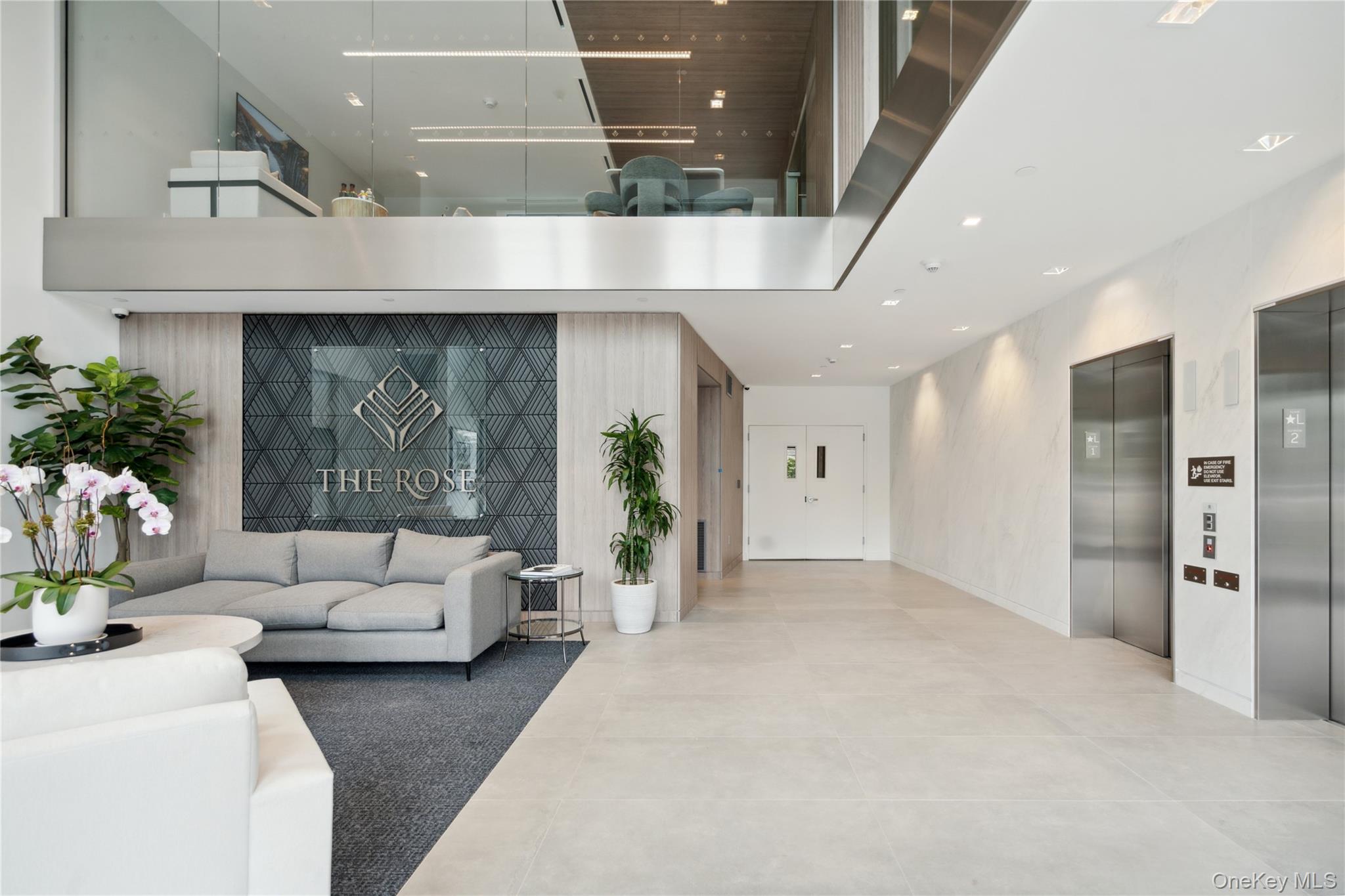 218 Middle Neck Road, Unit 211 Great Neck, NY 11021 - Photo 8 of 20 Building lobby featuring a towering ceiling and recessed lighting