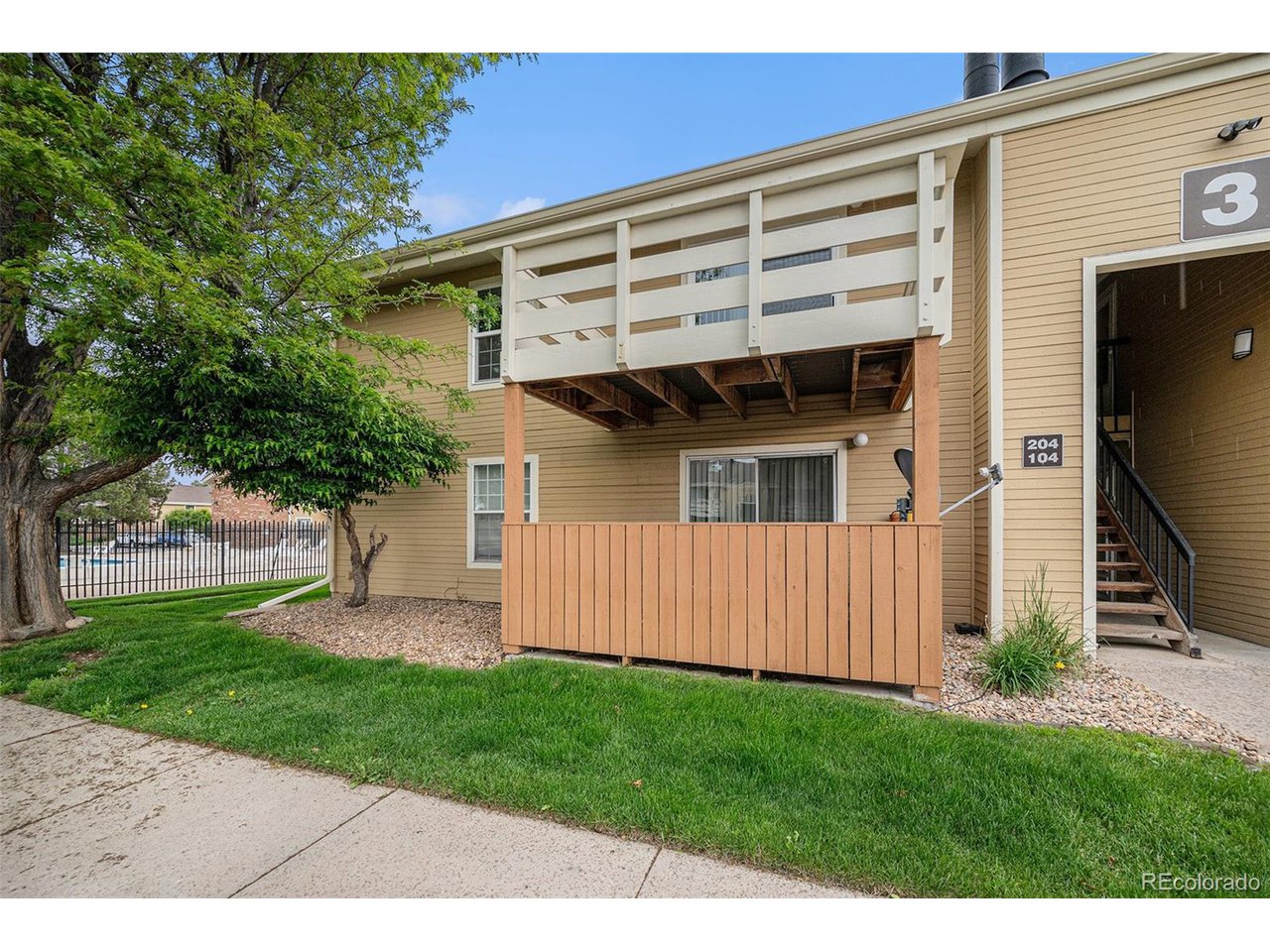 10251 West 44th Avenue, Unit 204 Wheat Ridge, CO 80033 - Photo 12 of 13 a front view of a house with a garden