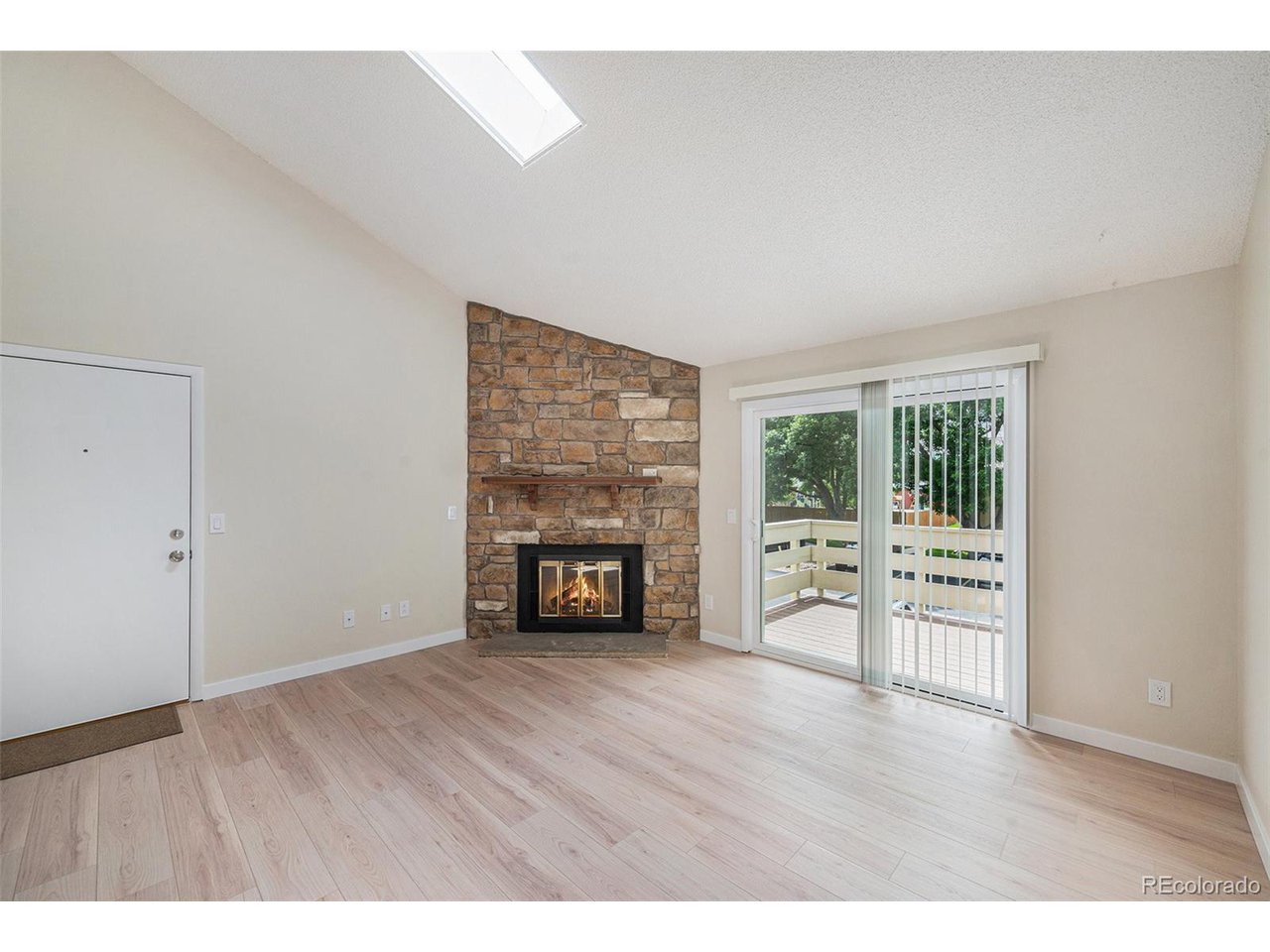 10251 West 44th Avenue, Unit 204 Wheat Ridge, CO 80033 - Photo 6 of 13 a view of empty room with a fireplace and wooden floor