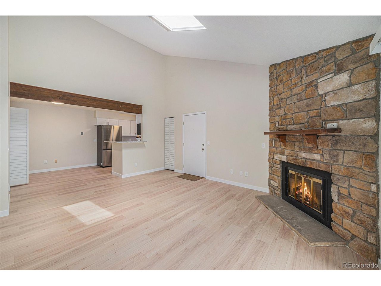 10251 West 44th Avenue, Unit 204 Wheat Ridge, CO 80033 - Photo 8 of 13 a view of empty room with a fireplace and wooden floor