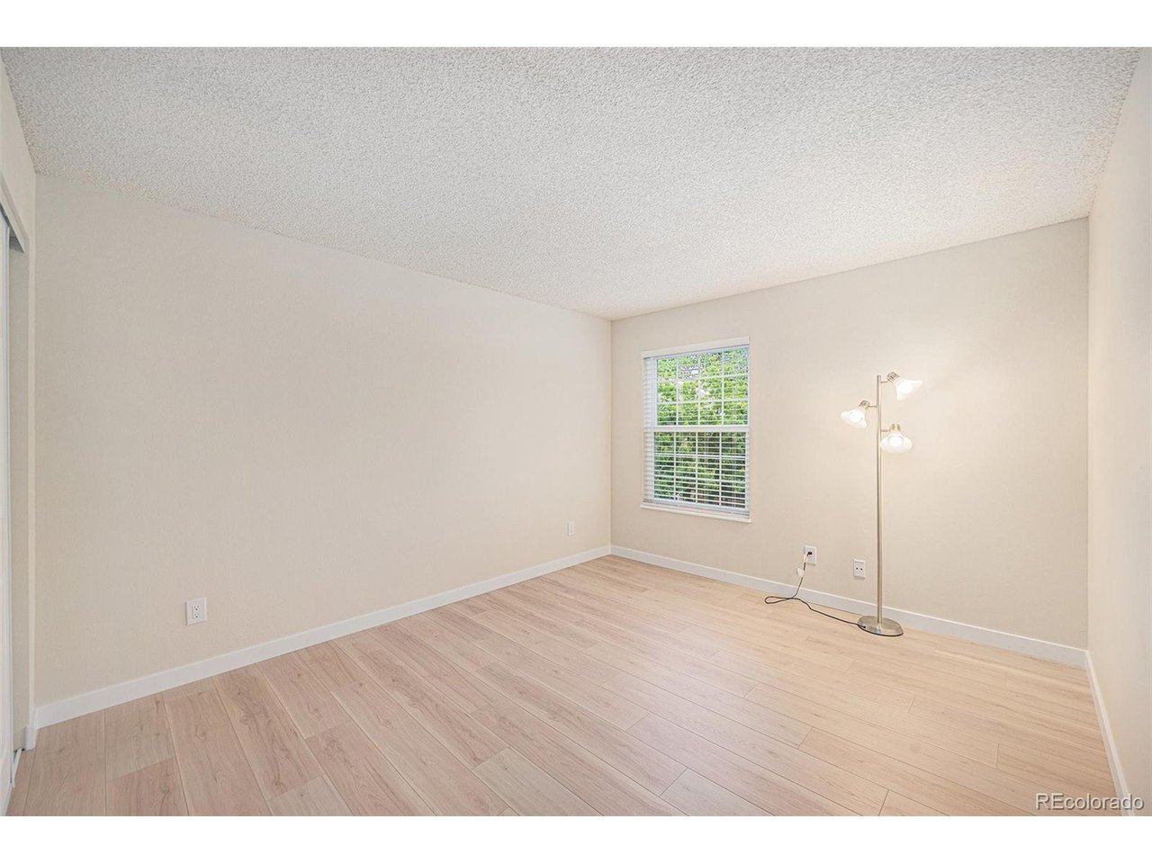 10251 West 44th Avenue, Unit 204 Wheat Ridge, CO 80033 - Photo 10 of 13 a view of empty room with wooden floor and fan