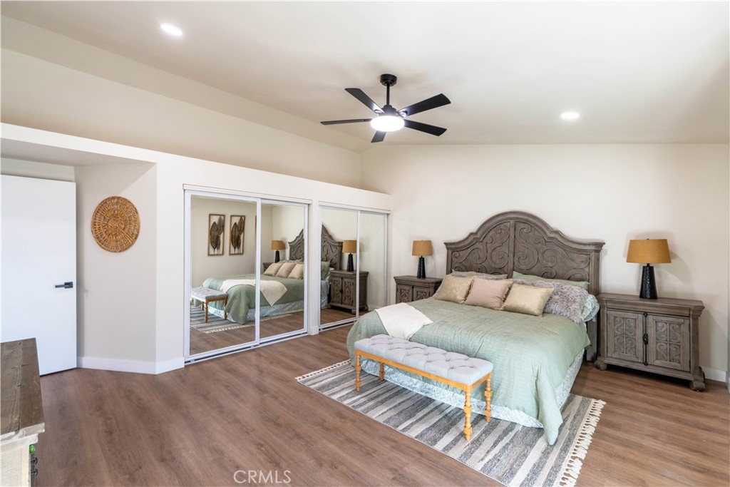 1182 North Elmwood Avenue Rialto, CA 92376 - Photo 19 of 41 a bedroom with a large bed and a chandelier