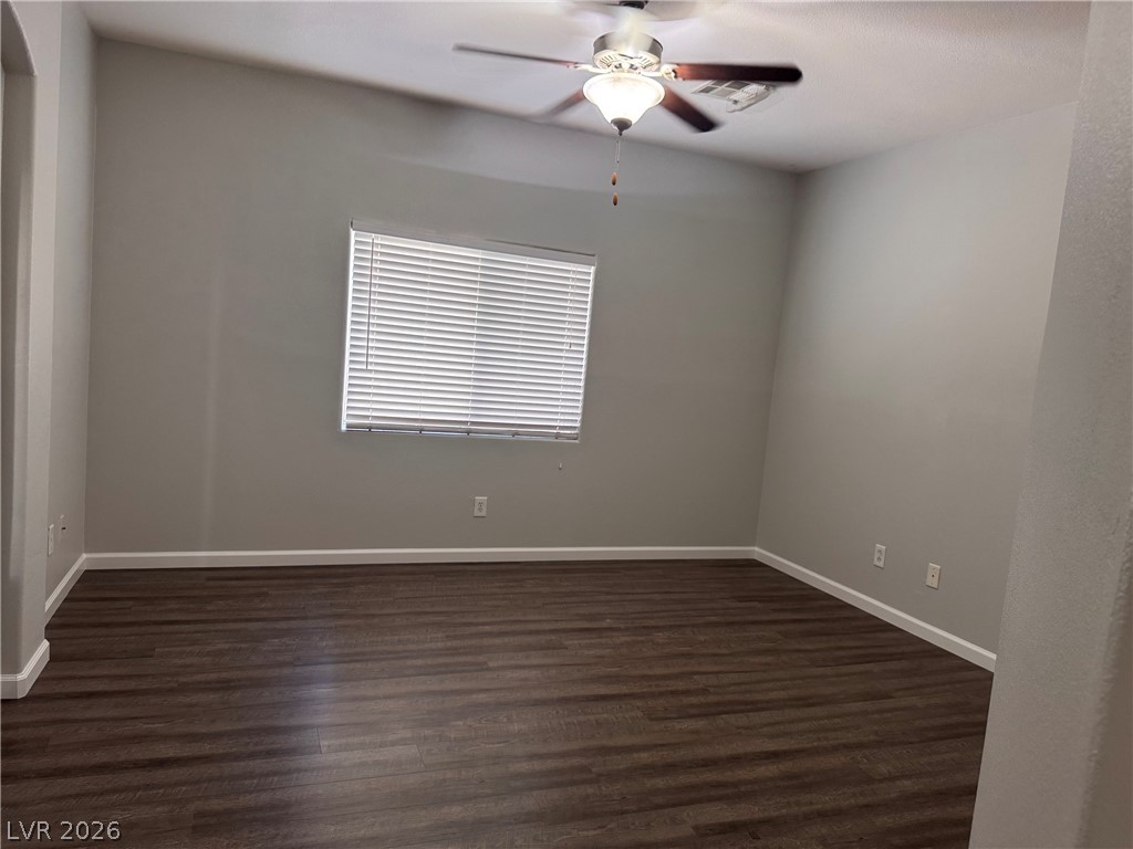 8937 Austin Ridge Avenue Las Vegas, NV 89178 - Photo 18 of 22 An airy bedroom with rich wood-toned flooring features a ceiling fan and natural light.
