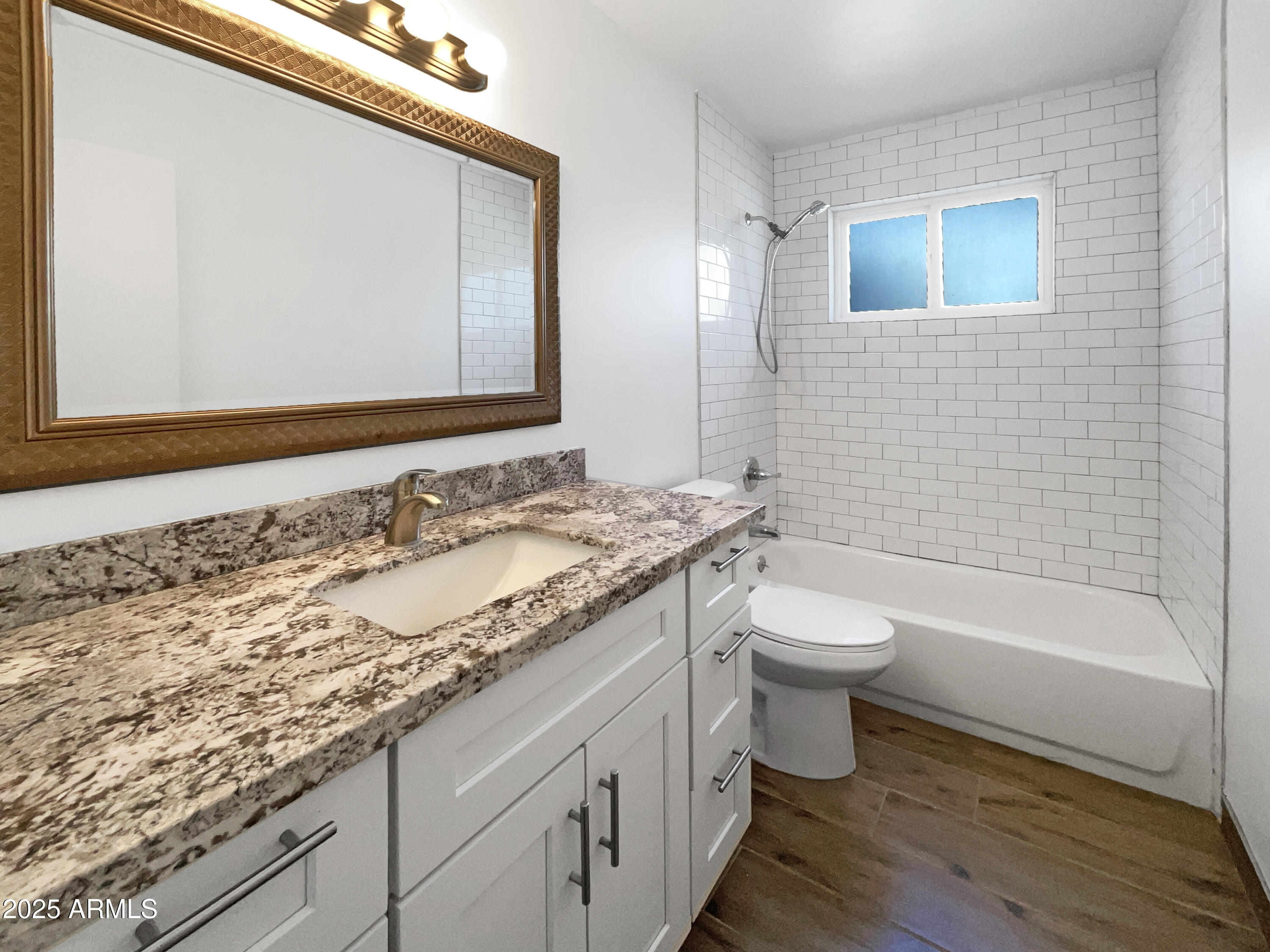 7231 North 23rd Avenue Phoenix, AZ 85021 - Photo 6 of 28 a bathroom with a granite countertop sink a toilet and a bathtub