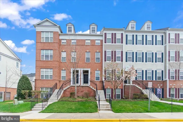 a front view of a residential apartment building with a yard