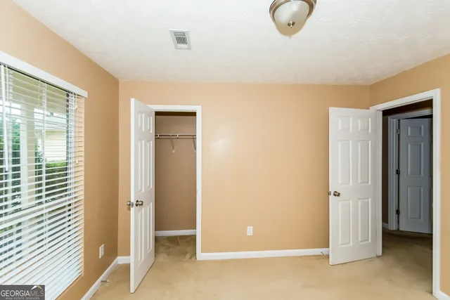 a view of a room with wooden floor and glass doors