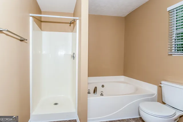 a white bath tub sitting next to a white toilet