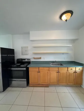 a kitchen with granite countertop a stove and a sink