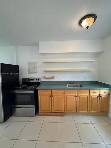 a kitchen with granite countertop a stove and a sink