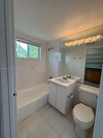 a bathroom with a sink a toilet and bathtub
