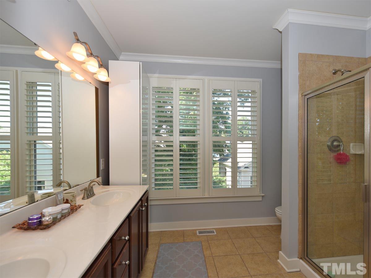 520 John Haywood Way, Unit 102 Raleigh, NC 27604 - Photo 14 of 18 a bathroom with a granite countertop sink and a bathtub