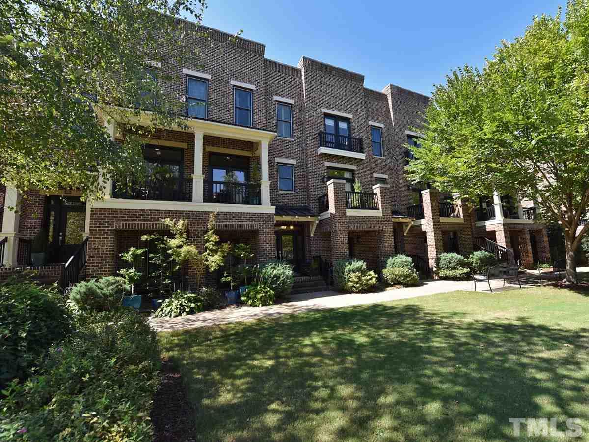 520 John Haywood Way, Unit 102 Raleigh, NC 27604 - Photo 17 of 18 a view of a building with a yard