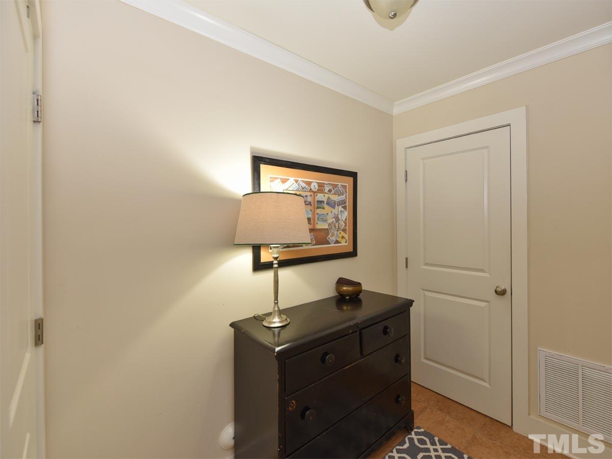 520 John Haywood Way, Unit 102 Raleigh, NC 27604 - Photo 3 of 18 a room with mirror cabinet and door