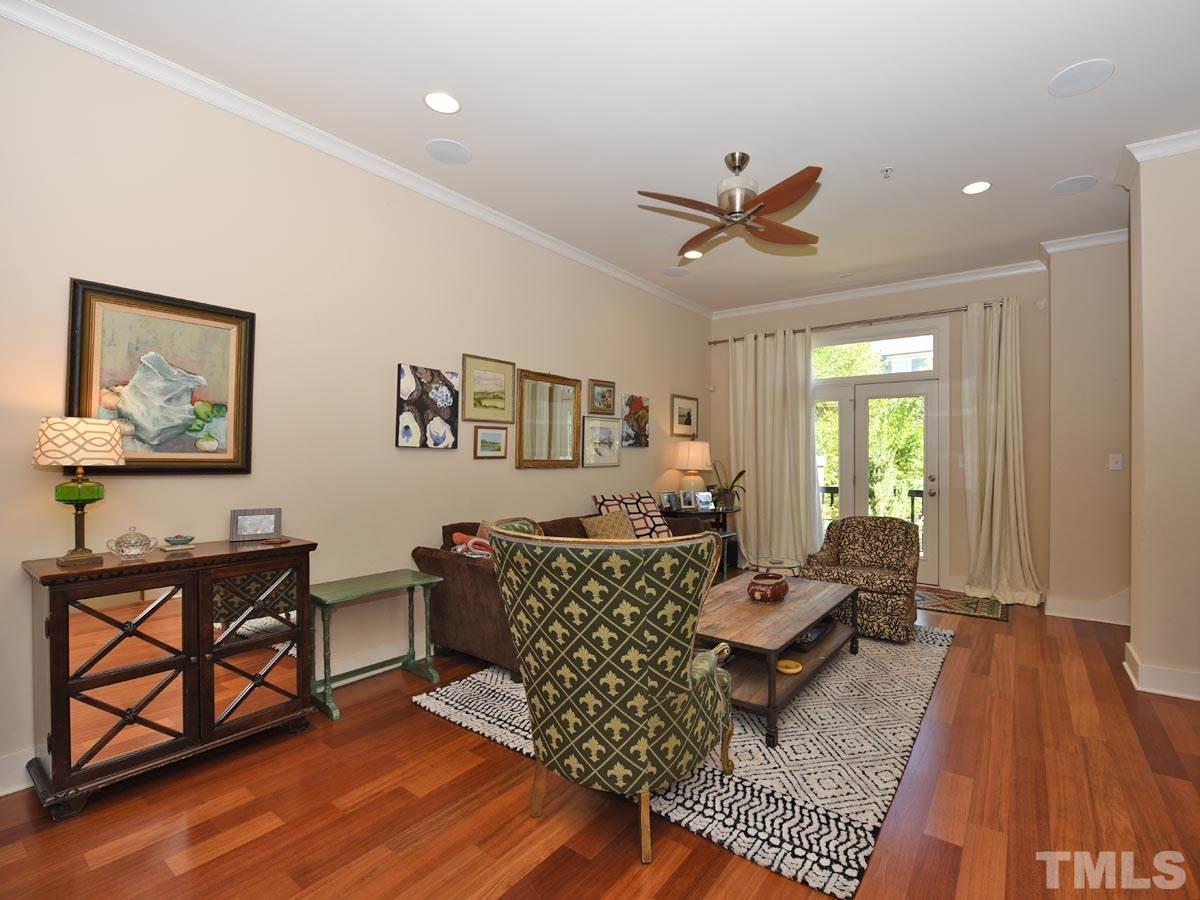 520 John Haywood Way, Unit 102 Raleigh, NC 27604 - Photo 5 of 18 a living room with furniture and a wooden floor