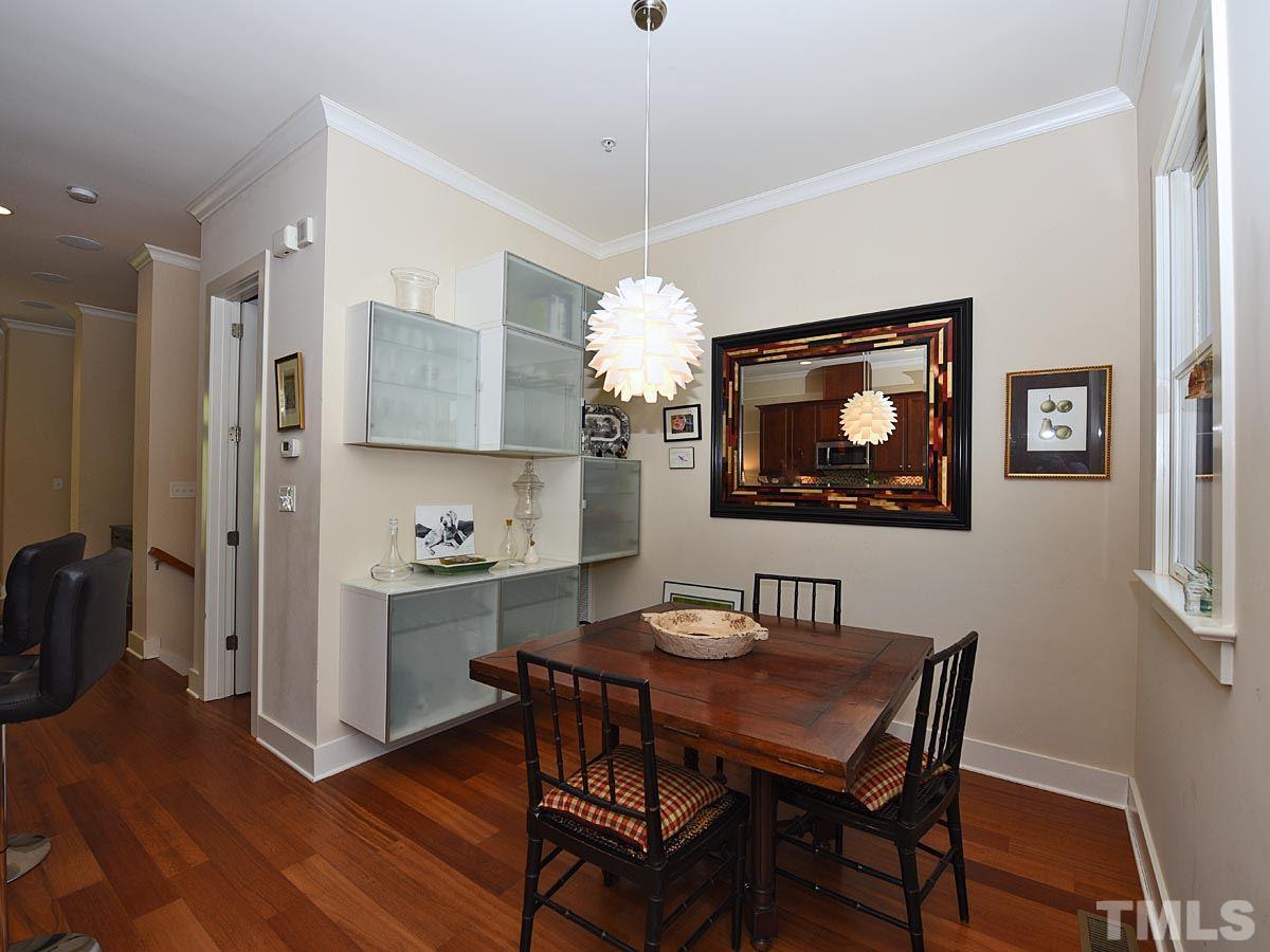 520 John Haywood Way, Unit 102 Raleigh, NC 27604 - Photo 8 of 18 a view of a dining room with furniture and wooden floor