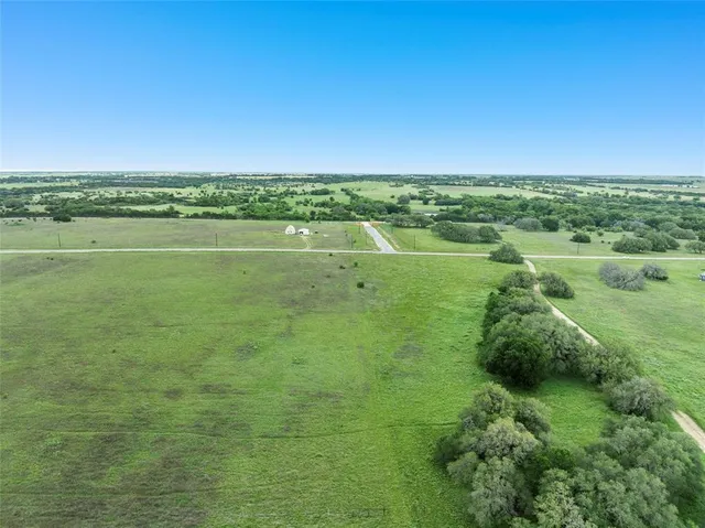 a view of outdoor space with green field and trees