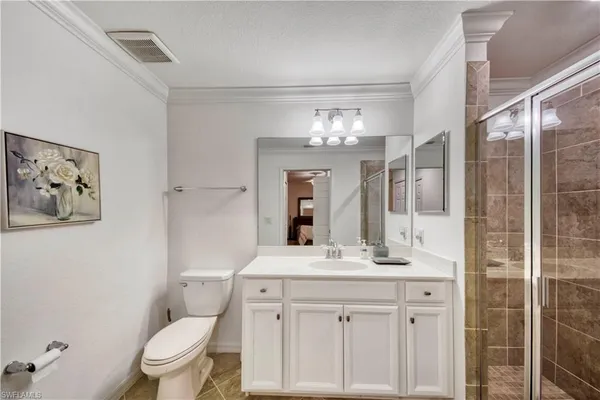 a bathroom with a sink vanity toilet and shower