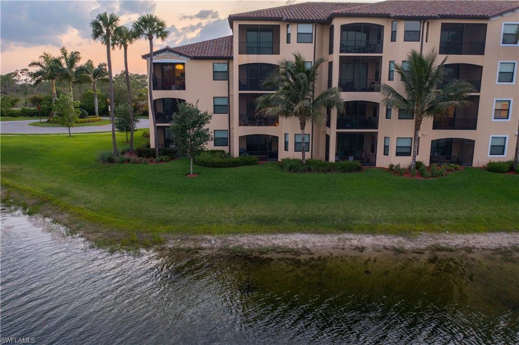 9572 Trevi Court, Unit 5017 Naples, FL 34113 - Photo 20 of 25 a front view of house with yard and green space