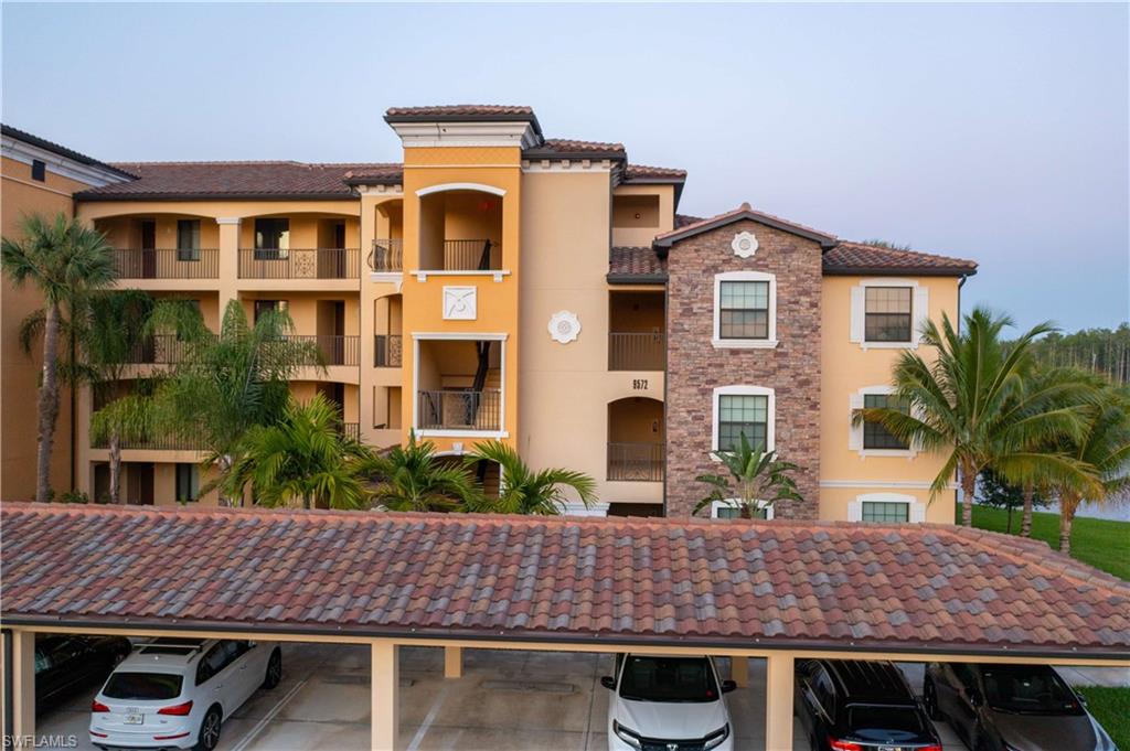 9572 Trevi Court, Unit 5017 Naples, FL 34113 - Photo 23 of 25 a front view of residential houses with yard and outdoor seating