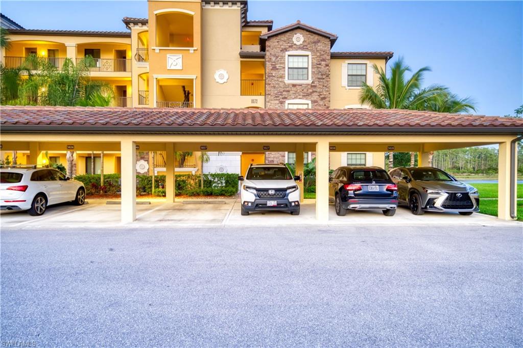 9572 Trevi Court, Unit 5017 Naples, FL 34113 - Photo 24 of 25 a view of a car parked in front of a building