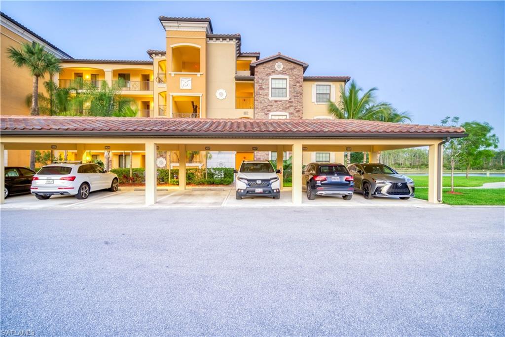 9572 Trevi Court, Unit 5017 Naples, FL 34113 - Photo 25 of 25 a couple of cars parked in front of a building
