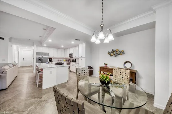 a living room with kitchen island furniture and a chandelier