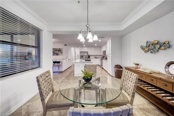 a dining room with furniture a rug and a chandelier