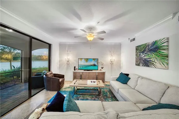 a living room with furniture fireplace and a large window